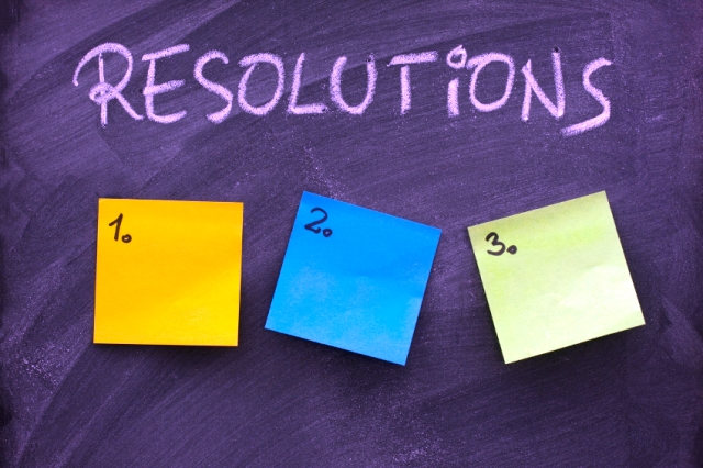 list of resolutions on blackboard with three blank, numbered sticky notes