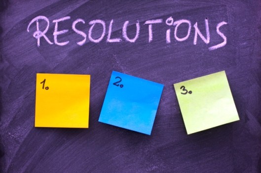 list of resolutions on blackboard with three blank, numbered sticky notes